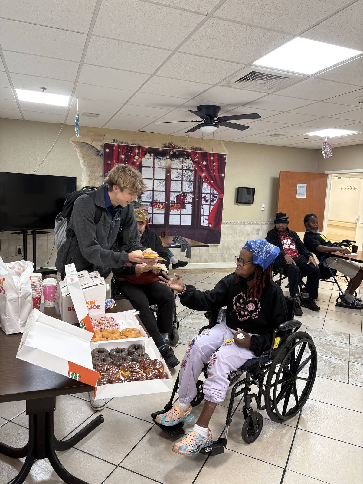 Q's Transportation team visiting with residents at a local day center