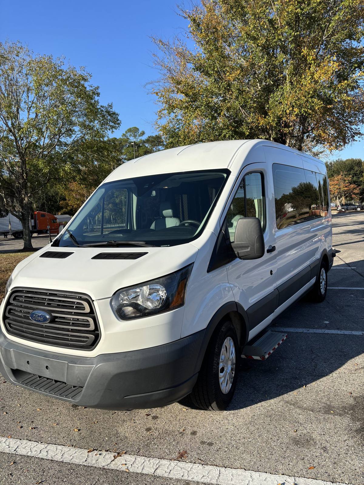 Q's Transportation wheelchair-accessible Ford Transit van parked outside