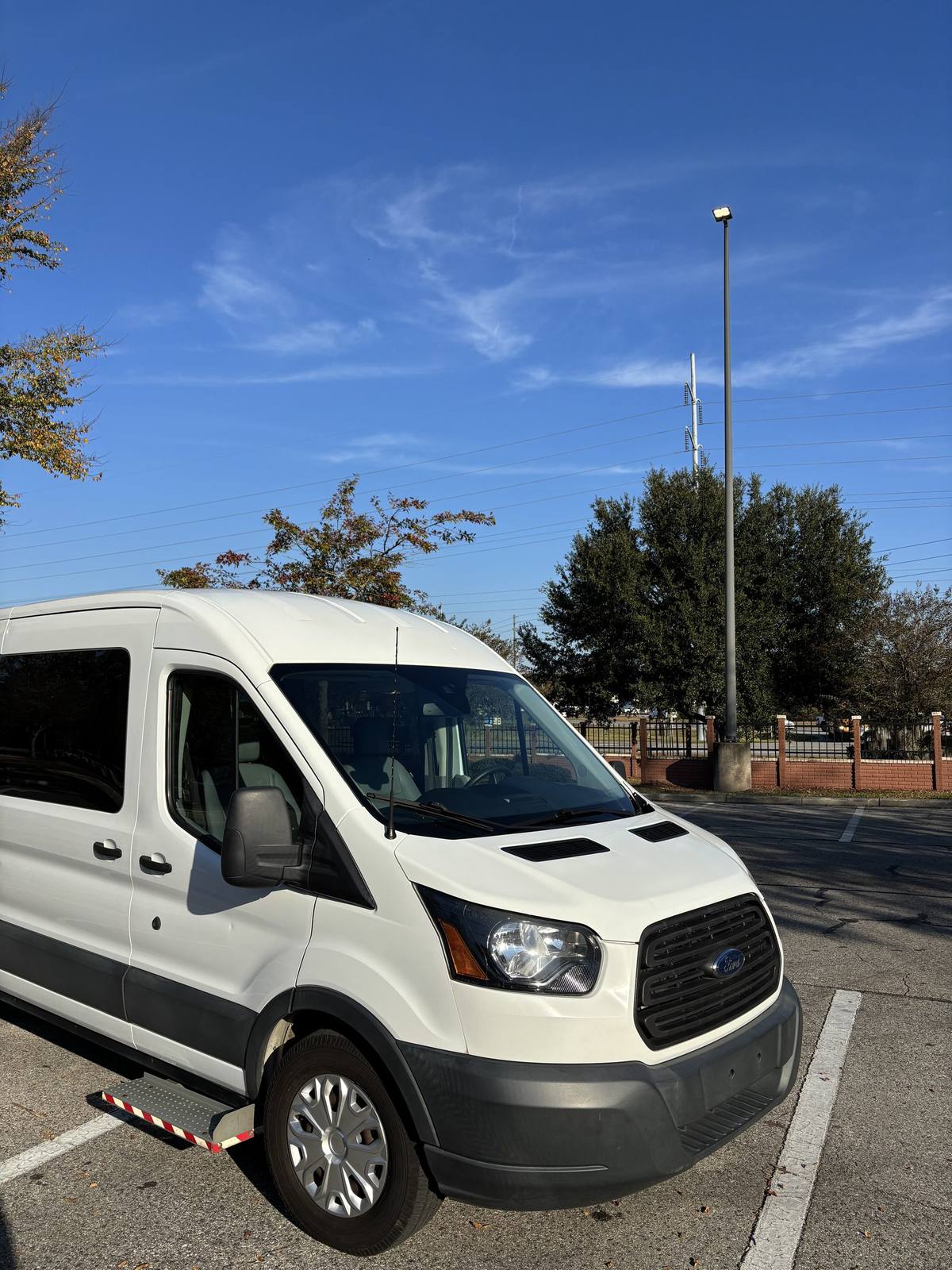 Front view of Q's Transportation Ford Transit 350 van